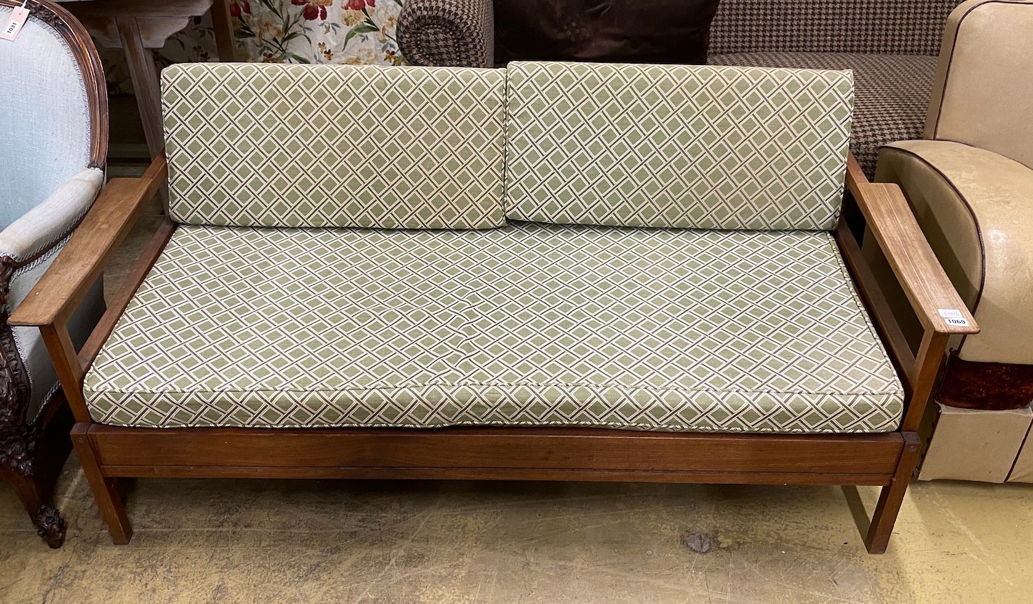 A mid century Guy Rogers style teak daybed with drop arms, width 150cm, depth 70cm, height 64cm